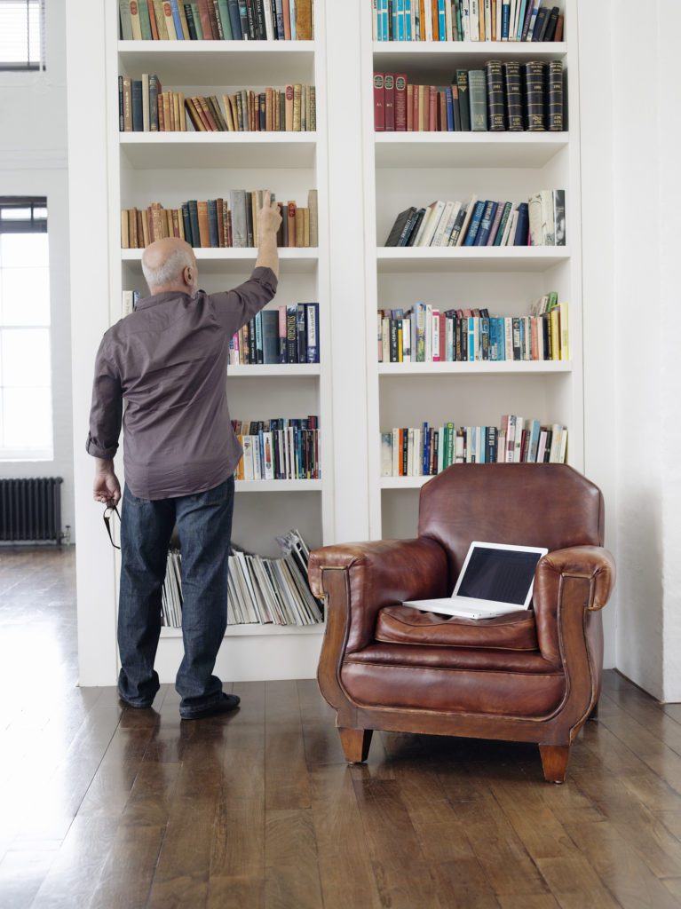 Man Taking Book Out of Shelf
